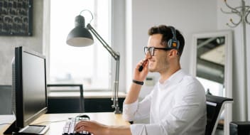 a customer support agent in front of a computer