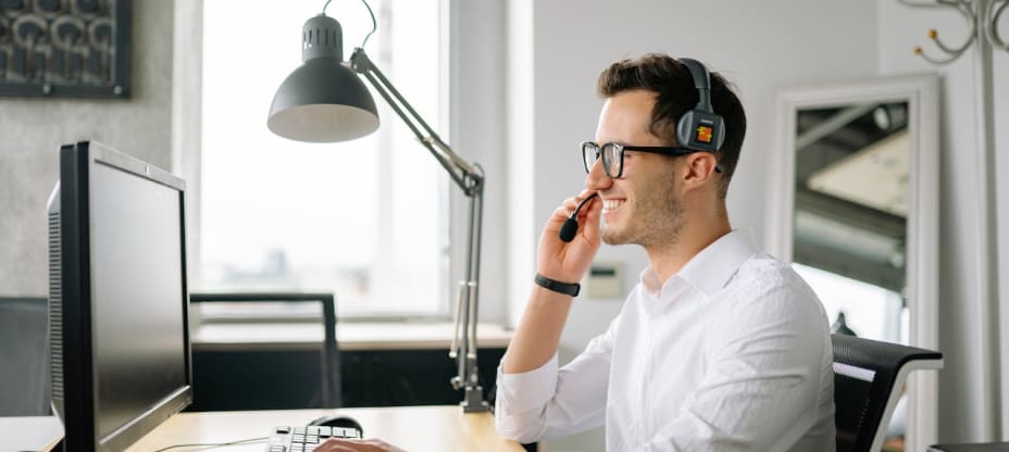 a customer support agent in front of a computer