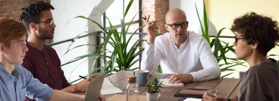 people sitting at a desk at a business meeting