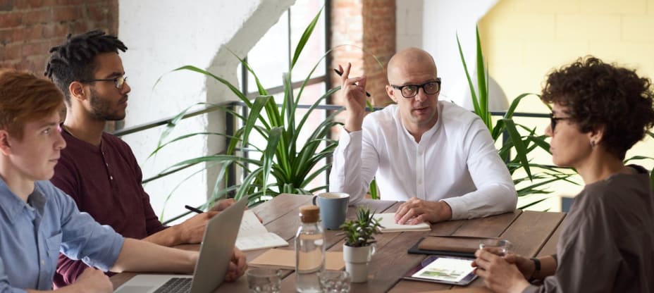 people sitting at a desk at a business meeting