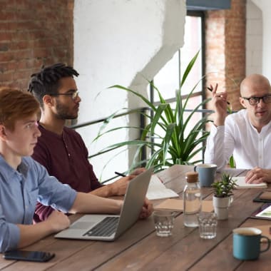 people sitting at a desk at a business meeting