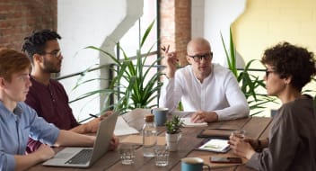 people sitting at a desk at a business meeting