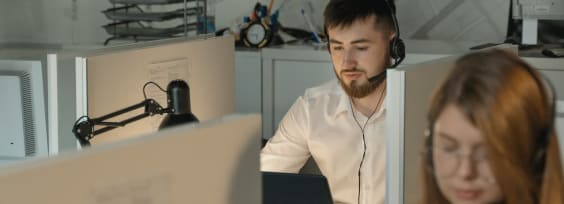 a man sitting in front of a computer in an open space