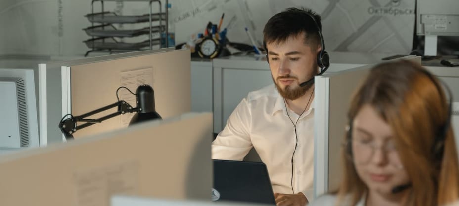 a man sitting in front of a computer in an open space