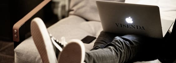 Person sitting on the coach with their Macbook