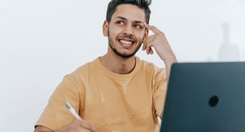 A man sitting at a desk and thinking