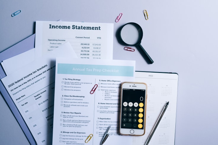 documents and phone lying on desk as different sources of knowledge