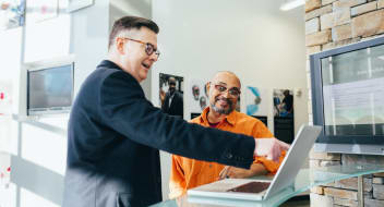 men discussing over a laptop