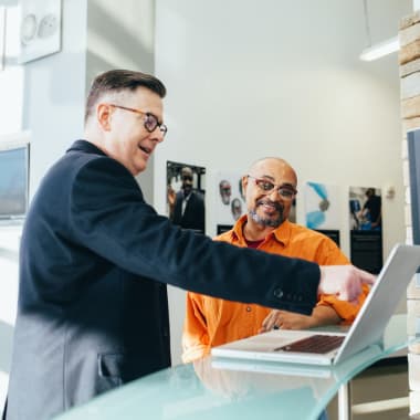 men discussing over a laptop