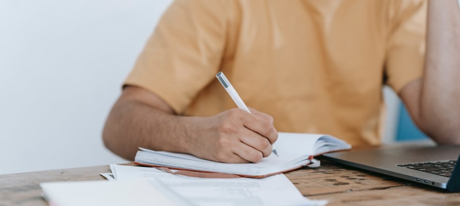 A man sitting at a desk with papers and a computer