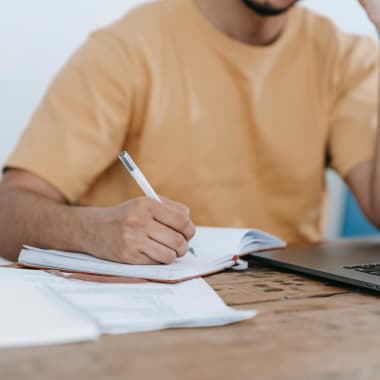 A man sitting at a desk with papers and a computer