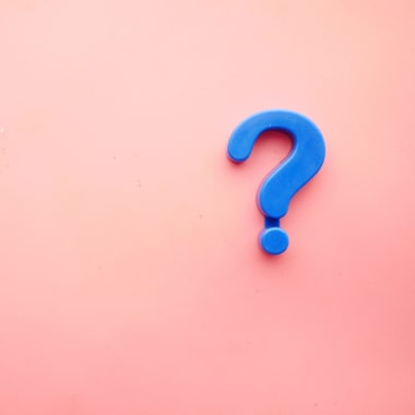 Blue question mark on pink background