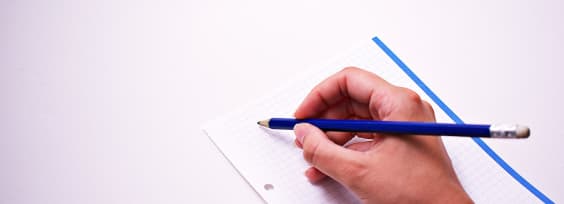 a hand holding a pencil over a sheet of paper